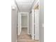 Hallway with neutral paint, wood look floors, and doors to the other rooms in the house at 326 Marion Oaks Trl, Ocala, FL 34473
