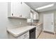 Well-maintained kitchen with white cabinets, neutral countertops, and stainless steel appliances at 326 Marion Oaks Trl, Ocala, FL 34473