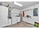 Laundry room with washer, dryer, water heater, and shelving for storage at 326 Marion Oaks Trl, Ocala, FL 34473