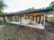 Covered back porch with ceiling fan, French doors, and outdoor seating at 1507 Wheeler Rd, Apopka, FL 32703