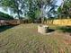 Backyard featuring large, stone fire pit with wooden fence surround at 1507 Wheeler Rd, Apopka, FL 32703