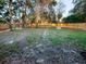 Fenced backyard with well-manicured lawn and stone fire pit at 1507 Wheeler Rd, Apopka, FL 32703