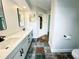 Bathroom boasting a double vanity, sleek mirrors, modern fixtures, and elegant flooring at 1507 Wheeler Rd, Apopka, FL 32703
