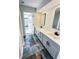 Bathroom featuring a double vanity, modern mirrors, black hardware and stylish tile flooring at 1507 Wheeler Rd, Apopka, FL 32703