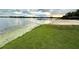 Wonderful view of a community sandy beach and pier with lake views and sunset skies at 1507 Wheeler Rd, Apopka, FL 32703