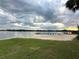 Sandy community beach by the lake with a swimming zone and a pier for boats and recreation at 1507 Wheeler Rd, Apopka, FL 32703