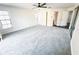 Light-filled primary bedroom with carpet, neutral walls, windows with blinds, and a ceiling fan at 1507 Wheeler Rd, Apopka, FL 32703
