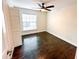 Cozy bedroom with hardwood floors, a ceiling fan, and ample natural light, creating a peaceful retreat at 1507 Wheeler Rd, Apopka, FL 32703