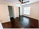 Comfortable bedroom boasting hardwood floors, a ceiling fan, and closet, perfect for relaxation at 1507 Wheeler Rd, Apopka, FL 32703
