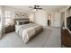 This bedroom boasts large windows, ceiling fan and an attached bathroom at 1507 Wheeler Rd, Apopka, FL 32703
