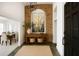 Inviting entryway features brick archway, decor, console table, and dark trim door at 1507 Wheeler Rd, Apopka, FL 32703