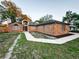 Expansive view of the brick home with a pathway, and surrounding trees giving a sense of peace and serenity at 1507 Wheeler Rd, Apopka, FL 32703