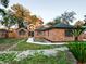 Charming brick home with well-manicured lawn and mature landscaping at 1507 Wheeler Rd, Apopka, FL 32703