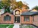 Stately brick home featuring a well-manicured lawn, dormer, and multi-paned windows at 1507 Wheeler Rd, Apopka, FL 32703