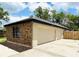 Spacious three-car garage with brick siding, offering ample parking and storage space at 1507 Wheeler Rd, Apopka, FL 32703