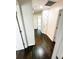 Hallway featuring rich hardwood floors, white doors, and neutral walls, creating a bright and airy space at 1507 Wheeler Rd, Apopka, FL 32703