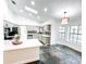 Spacious kitchen features white cabinets, quartz countertops, and slate floors at 1507 Wheeler Rd, Apopka, FL 32703
