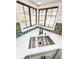 Modern kitchen sink with black faucet, designer backsplash and corner windows overlooking backyard at 1507 Wheeler Rd, Apopka, FL 32703