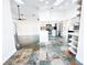 Open concept kitchen with bar area, stainless appliances, and unique flooring at 1507 Wheeler Rd, Apopka, FL 32703