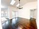 Open living room with hardwood floors, skylights, and access to the backyard at 1507 Wheeler Rd, Apopka, FL 32703