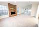 Expansive living room with neutral carpet, brick fireplace, and lots of natural light at 1507 Wheeler Rd, Apopka, FL 32703