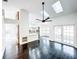 Open concept living room with skylights and hardwood floors flows into kitchen at 1507 Wheeler Rd, Apopka, FL 32703