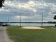 A charming community volleyball court overlooking the lake with lighting for evening games at 1507 Wheeler Rd, Apopka, FL 32703
