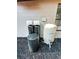 Well water treatment system next to home with visible filter tanks at 1507 Wheeler Rd, Apopka, FL 32703