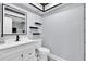 Modern bathroom features floating shelves, a white vanity, and neutral wall color at 1913 Poinsetta Ln, Maitland, FL 32751