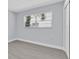 Bedroom with luxury vinyl plank flooring, light gray walls, and exterior window at 1913 Poinsetta Ln, Maitland, FL 32751