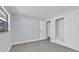 Bright bedroom features light grey walls, grey flooring, and a large closet with white doors at 1913 Poinsetta Ln, Maitland, FL 32751