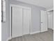 Bedroom with light gray walls, luxury vinyl plank flooring, and closet with sliding doors at 1913 Poinsetta Ln, Maitland, FL 32751