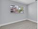 Bedroom with luxury vinyl plank flooring, light gray walls, and view of backyard at 1913 Poinsetta Ln, Maitland, FL 32751