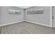 A light-filled room with grey wood-look floors and fresh neutral walls at 1913 Poinsetta Ln, Maitland, FL 32751
