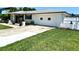 Exterior view showcasing a two-car garage and well-kept lawn, offering convenient parking at 1913 Poinsetta Ln, Maitland, FL 32751
