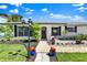 Inviting single-story house showcasing a beautifully landscaped front yard and stylish entrance at 1913 Poinsetta Ln, Maitland, FL 32751