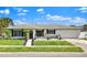 Charming single-story home featuring well-kept landscaping and a welcoming front entrance at 1913 Poinsetta Ln, Maitland, FL 32751