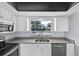 Close-up of kitchen with modern appliances and grey granite countertop at 1913 Poinsetta Ln, Maitland, FL 32751