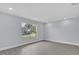 Bright living room with sleek, light gray floors and a large window overlooking the neighborhood at 1913 Poinsetta Ln, Maitland, FL 32751