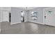 Bright living room with luxury vinyl plank flooring, light-colored walls, and exterior views at 1913 Poinsetta Ln, Maitland, FL 32751