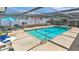 Sparkling pool in a screened enclosure surrounded by ample patio space for lounging and dining at 1913 Poinsetta Ln, Maitland, FL 32751