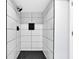 An updated shower showcasing dark tile accents and a convenient inset shelf at 1913 Poinsetta Ln, Maitland, FL 32751