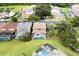 Aerial shot showcases houses with private pools, surrounded by green lawns and mature trees, in a suburban neighborhood at 8646 La Isla Dr, Kissimmee, FL 34747