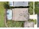 Aerial view of roof shows backyard pool with screened enclosure, palm trees, and neighboring houses at 8646 La Isla Dr, Kissimmee, FL 34747