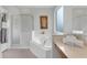 Bright bathroom featuring a soaking tub, glass-enclosed shower, and neutral finishes at 8646 La Isla Dr, Kissimmee, FL 34747