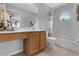 Bathroom featuring vanity, tile flooring, and bathtub with tiled surround and window at 8646 La Isla Dr, Kissimmee, FL 34747
