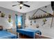 Whimsical bedroom featuring twin beds, unique wallpaper, and playful decor at 8646 La Isla Dr, Kissimmee, FL 34747