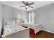 Stylish bedroom showcasing twin beds with patterned bedding and hardwood floors at 8646 La Isla Dr, Kissimmee, FL 34747