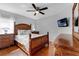 Cozy bedroom highlighting a carved bed frame, matching furniture, and ceiling fan at 8646 La Isla Dr, Kissimmee, FL 34747