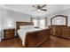 The bedroom features wood flooring, a ceiling fan, and a dresser with mirror at 8646 La Isla Dr, Kissimmee, FL 34747
